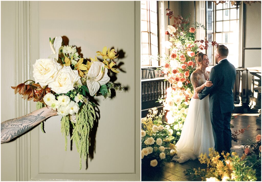 A bride and groom stand beside a floral installation in a film wedding photo at Colony House Newport.