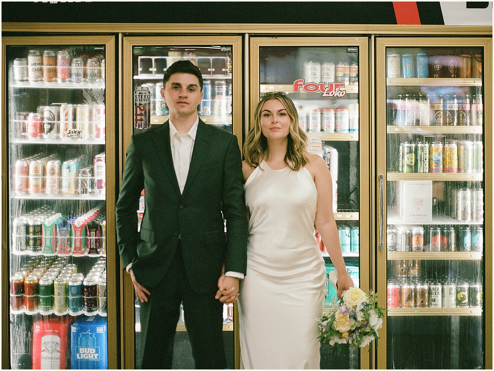 A bride and groom hold hands in front of a convenient store cooler before they elope in Portland.
