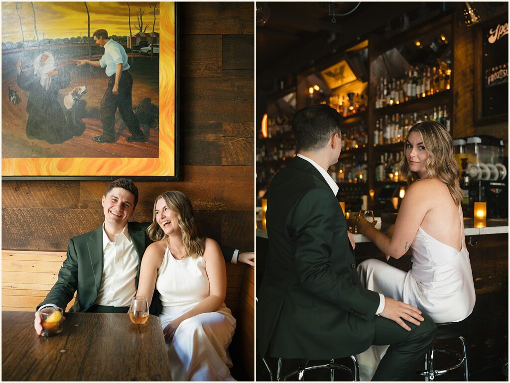 A bride and groom pose for a Portland wedding photographer in a booth at a bar.