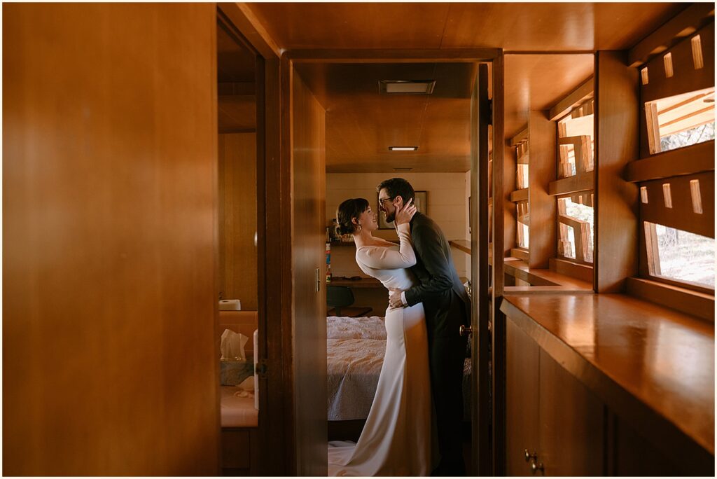 A bride and groom embrace in the hallway at the Gordon House before they elope in Portland.