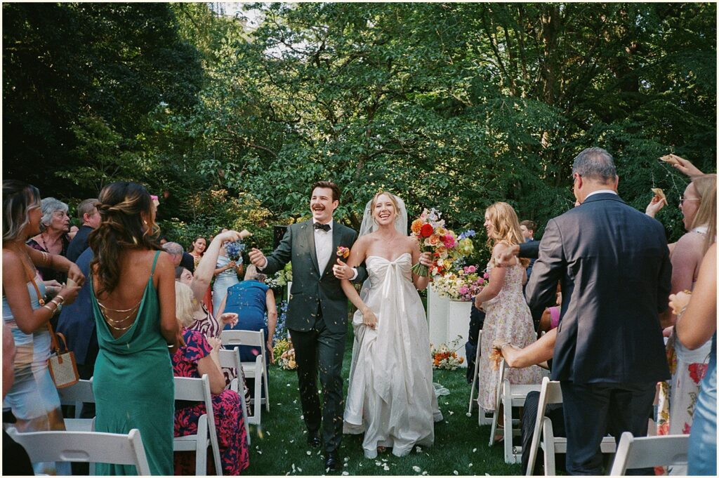 Wedding guests cheer during a recessional at a Portland wedding.